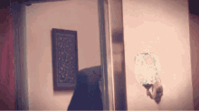 a room with a picture on the wall and a lamp