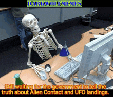 a skeleton wearing headphones sits at a desk with a computer monitor