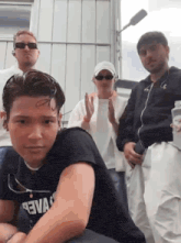 a group of people are posing for a picture and one of them is wearing a shirt that says ' aewa '