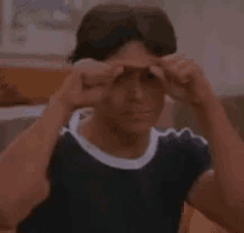 a young man is making a funny face and says yêu em nhu in a foreign language .