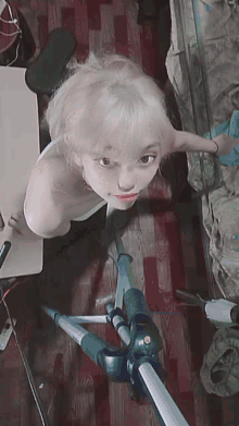 a woman with white hair is taking a picture of herself