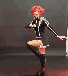 a woman in a red wig and black boots stands on one leg