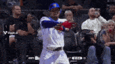 a baseball player in a cubs uniform stands in the stands