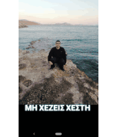 a man is kneeling on a rock near the ocean with the words mh xezeis xesth above him