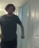 a man with a beard is standing in a hallway