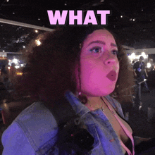 a woman with a surprised look on her face and the words what above her