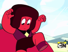 a red cartoon character is sitting on a red couch with a cn logo in the corner