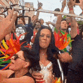 a crowd of people are gathered at a party and one woman is wearing a feathered headband