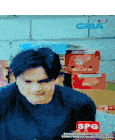 a man is sitting in front of a stack of boxes and a sign that says spg