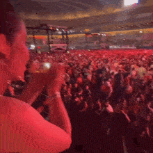 a woman is standing in front of a crowd of people