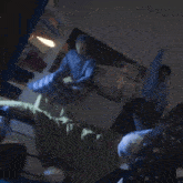 a man in a blue shirt and white pants is dancing