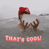 a woman in a red hat is holding a large piece of ice in her hands with the words that 's cool written below her