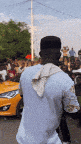 a man with a towel around his neck is standing in front of a crowd of people