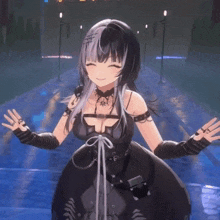 a girl in a black dress is standing in front of a body of water