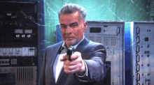 a man in a suit and tie is pointing a gun