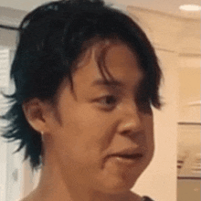 a close up of a person 's face with their mouth open .