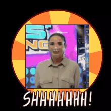 a woman wearing a face shield is standing in front of a sign that says shhhh