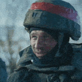 a close up of a soldier wearing a helmet with tape on it