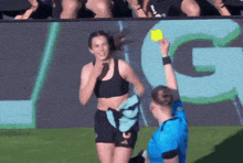 a referee giving a yellow card to a female athlete