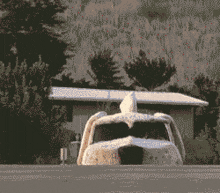 a pixelated image of a house with a car in the foreground