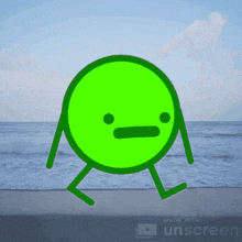a green cartoon character is walking on the beach