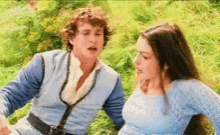 a man and a woman are talking to each other in a field .