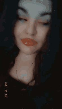 a close up of a woman 's face with her mouth open and her tongue sticking out .