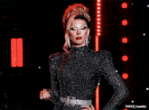 a woman in a black and silver dress is standing in front of a red light and says tumblr on the bottom