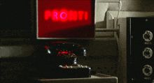 a phone sits in front of a sign that says pronti onda