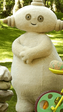 a stuffed animal with horns is standing next to a green toy