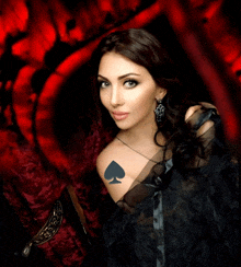 a woman has a spade tattoo on her arm