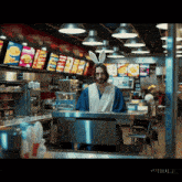 a man wearing bunny ears is standing at a counter in a fast food restaurant
