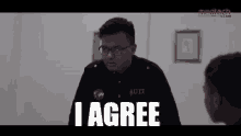 a man with utp on his shirt is talking to a woman and says " i agree "