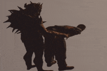 a silhouette of a man being lifted by a demon