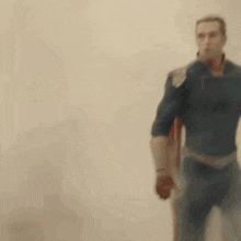 a man in a superhero costume with a light beam coming out of his eyes