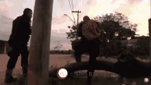 two soldiers standing next to a pole with the words actual rj on the bottom