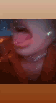a close up of a person 's face with their tongue hanging out .