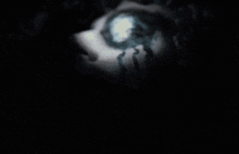a close up of a person 's face with a blue light coming out of it