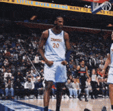 a basketball player wearing a jersey that says district 20 on it