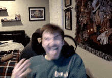 a man wearing a shirt that says crew is laughing
