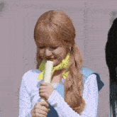 a girl with long black hair is wearing a blue sash that says ' hyun ' on the shoulder