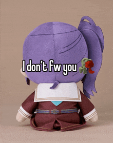 a stuffed animal with purple hair and the words " i don t fw you " written on it