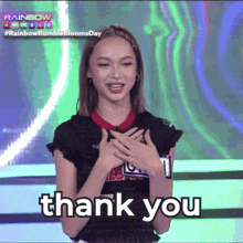 a woman with her hands on her chest and the words thank you below her