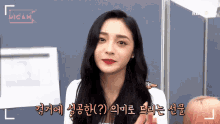 a woman with long black hair and red lipstick says hicam in pink