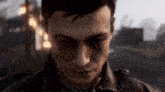 a close up of a man with his eyes closed