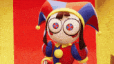 a cartoon character wearing a colorful jester hat