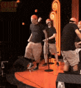 a group of men are standing on a stage with a sign that says jeremiah