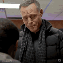 a man wearing a scarf and a jacket with the hashtag #chicagopd on the bottom right
