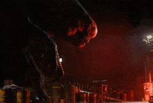 a man stands in a dark room with a fire coming out of the ceiling