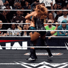 a woman in a wrestling ring with a sign that says back